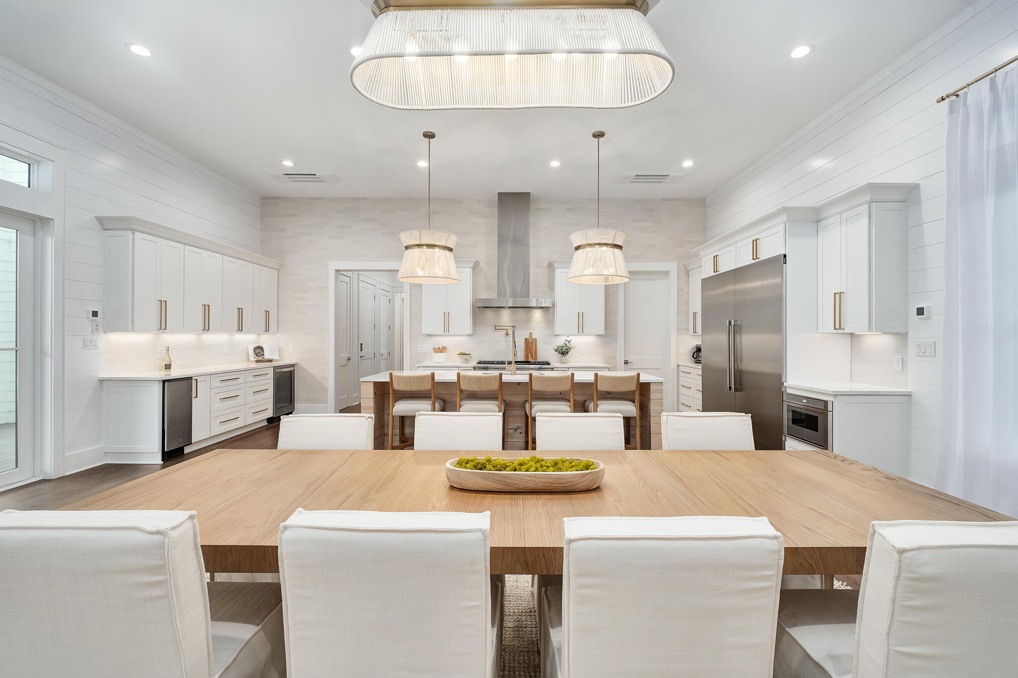 65 South Gulf Drive Santa Rosa Beach, FL 32459 - Photo 2 of 42 a large kitchen with kitchen island a white counter space a sink and cabinets