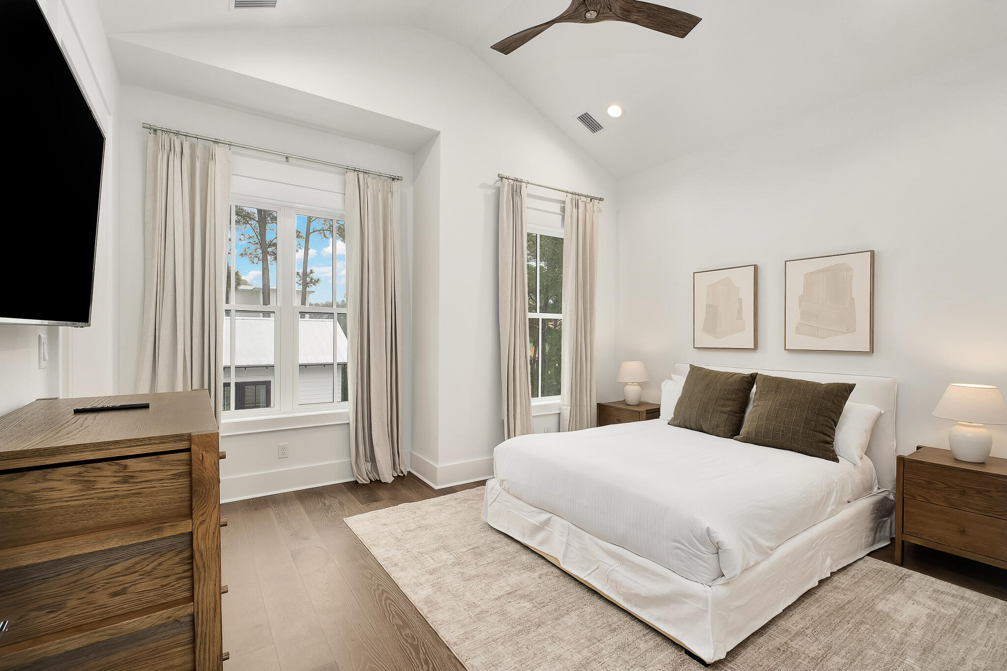 65 South Gulf Drive Santa Rosa Beach, FL 32459 - Photo 31 of 42 a bedroom with a large bed and a flat tv screen on dresser