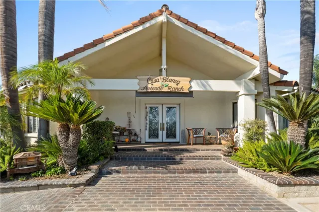 a view of a house with potted plants