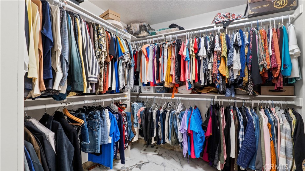 17850 Vista Del Lago Drive Riverside, CA 92503 - Photo 13 of 47 a view of walk in closet with clothes