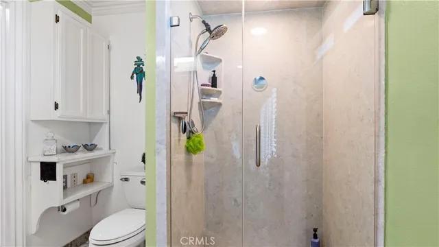 a bedroom with a bed a tv and wooden floor