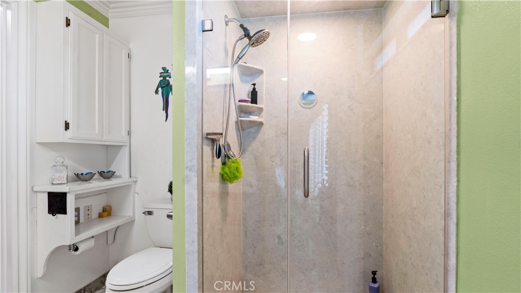 17850 Vista Del Lago Drive Riverside, CA 92503 - Photo 15 of 47 a bathroom with a sink a toilet and shower curtain