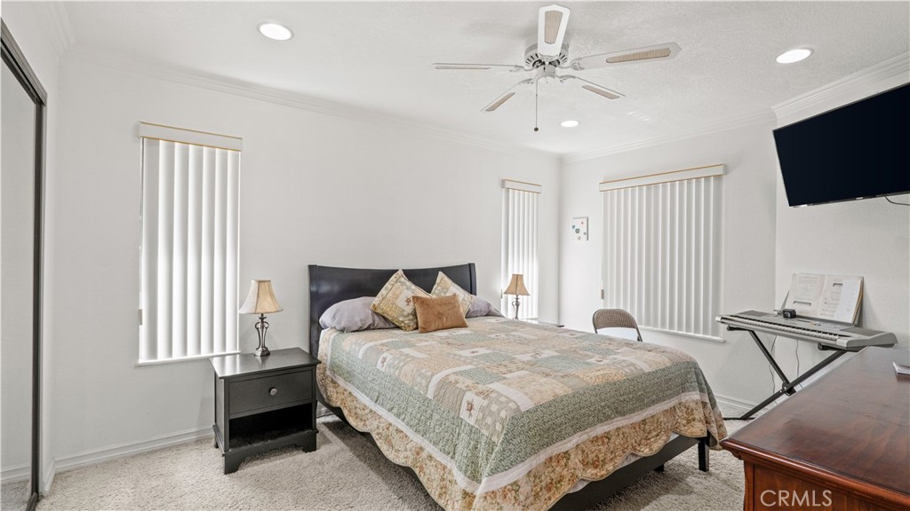 17850 Vista Del Lago Drive Riverside, CA 92503 - Photo 16 of 47 a bedroom with a bed a tv and wooden floor