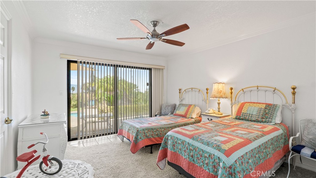 17850 Vista Del Lago Drive Riverside, CA 92503 - Photo 17 of 47 a bedroom with a bed and a chandelier