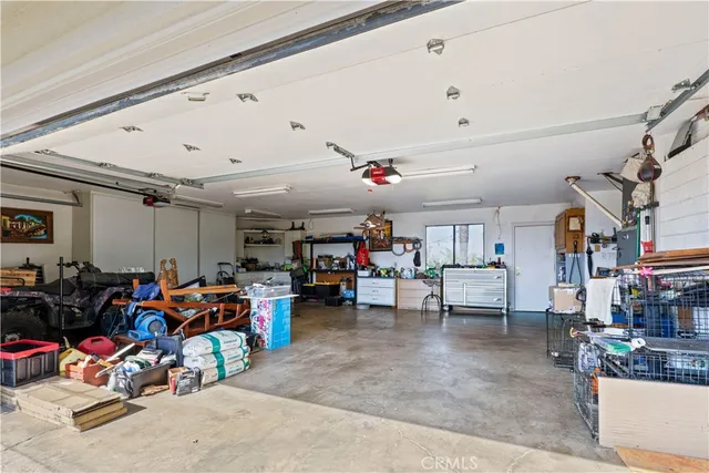a living room with furniture and a kitchen