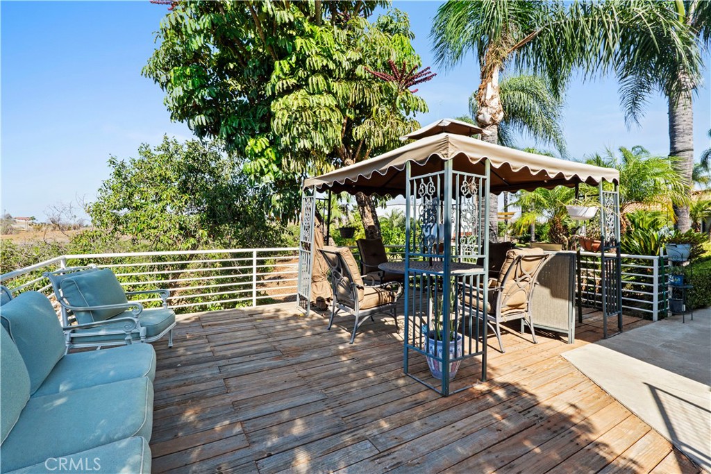 17850 Vista Del Lago Drive Riverside, CA 92503 - Photo 19 of 47 a view of a chairs and table on the wooden deck