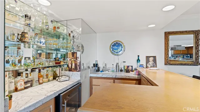 a kitchen with a sink a counter top space cabinets and stainless steel appliances