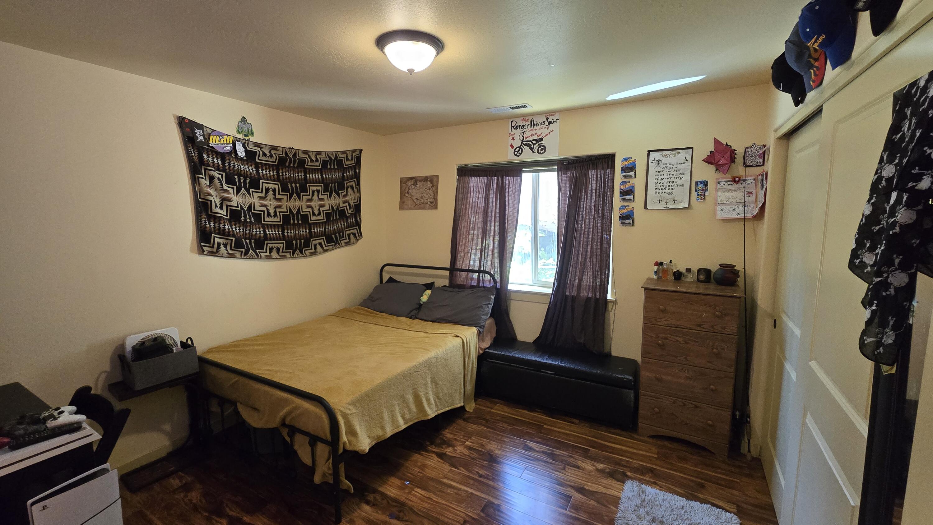 488 Crowson Road Ashland, OR 97520 - Photo 14 of 30 a bedroom with a bed and wooden floor