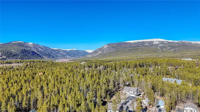 a view of mountain with sunset in background
