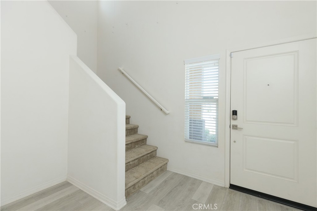 4875 Prairie Run Road Eastvale, CA 91752 - Photo 11 of 18 a view of entryway with stairs and wooden floor