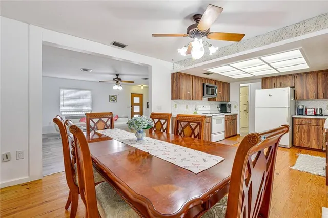 a kitchen with refrigerator cabinets and wooden floor