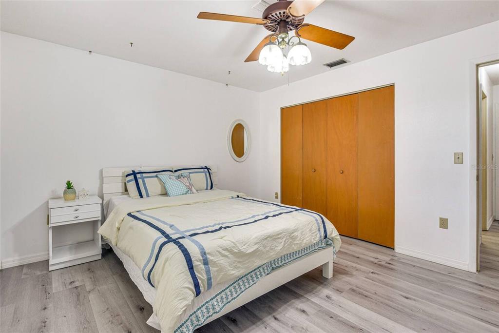 4831 Greenleaf Road Sarasota, FL 34233 - Photo 5 of 22 a bedroom with a bed and a chandelier