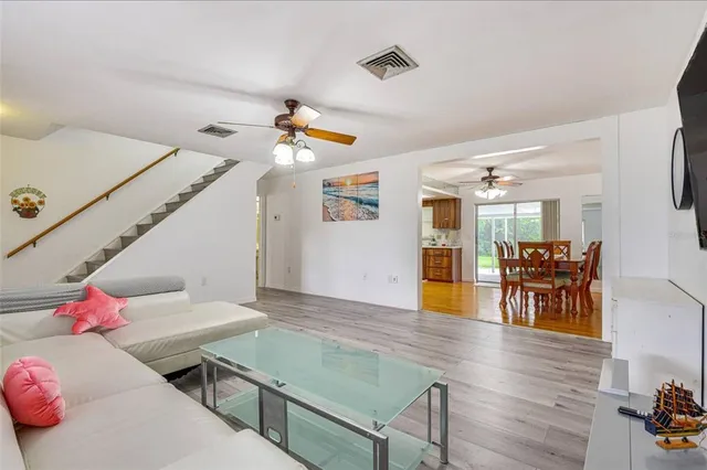 a living room with furniture wooden floor and window