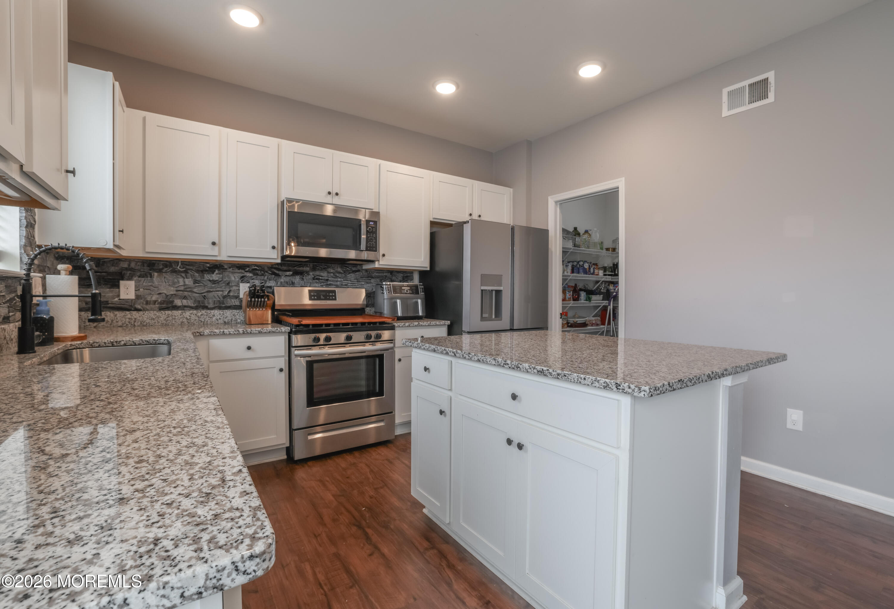 28 Dylan Boulevard Barnegat, NJ 08005 - Photo 14 of 51 a kitchen with stainless steel appliances granite countertop a stove a sink and a refrigerator