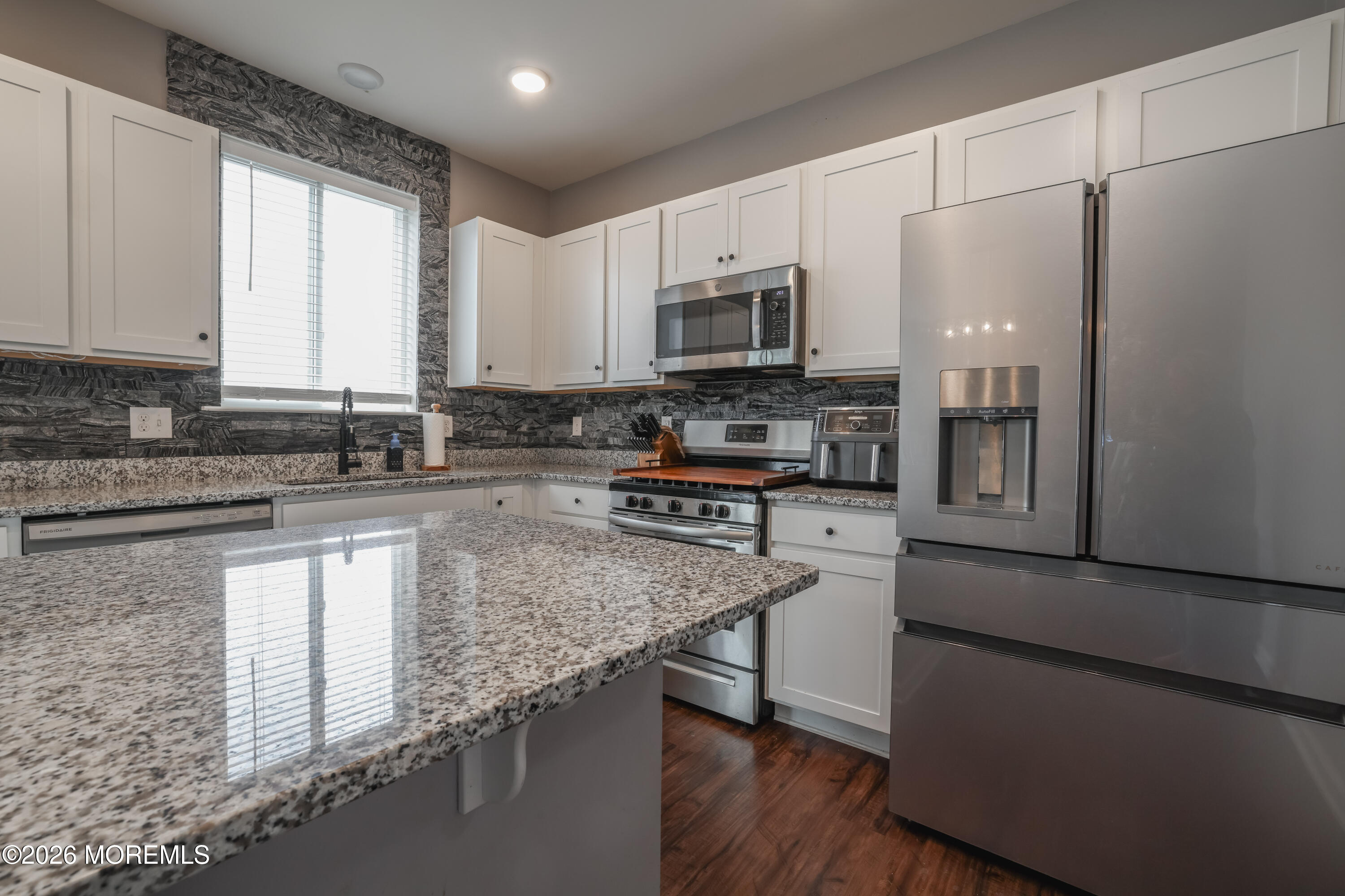 28 Dylan Boulevard Barnegat, NJ 08005 - Photo 15 of 51 a kitchen with stainless steel appliances granite countertop a stove a sink a refrigerator a microwave and cabinets