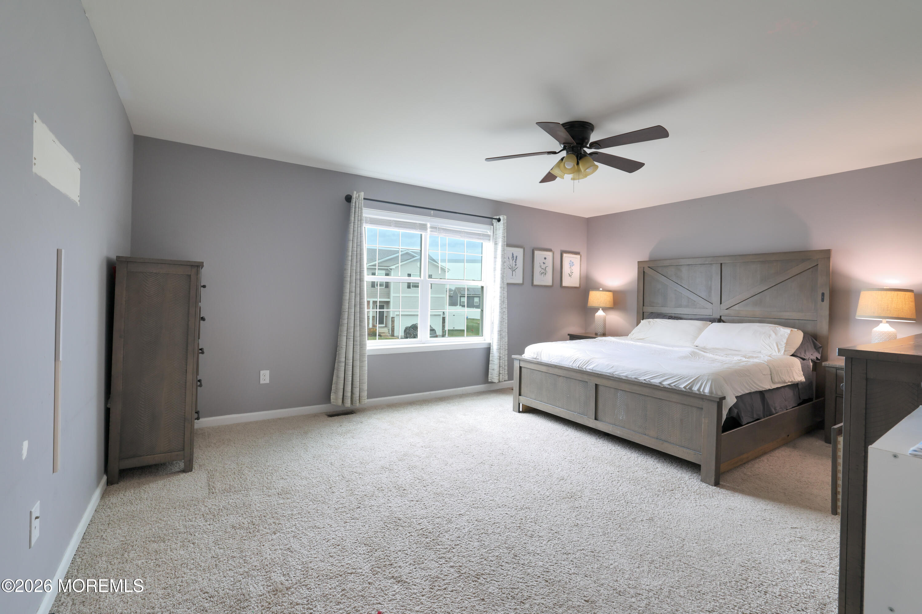 28 Dylan Boulevard Barnegat, NJ 08005 - Photo 26 of 51 a spacious bedroom with a bed and a chandelier