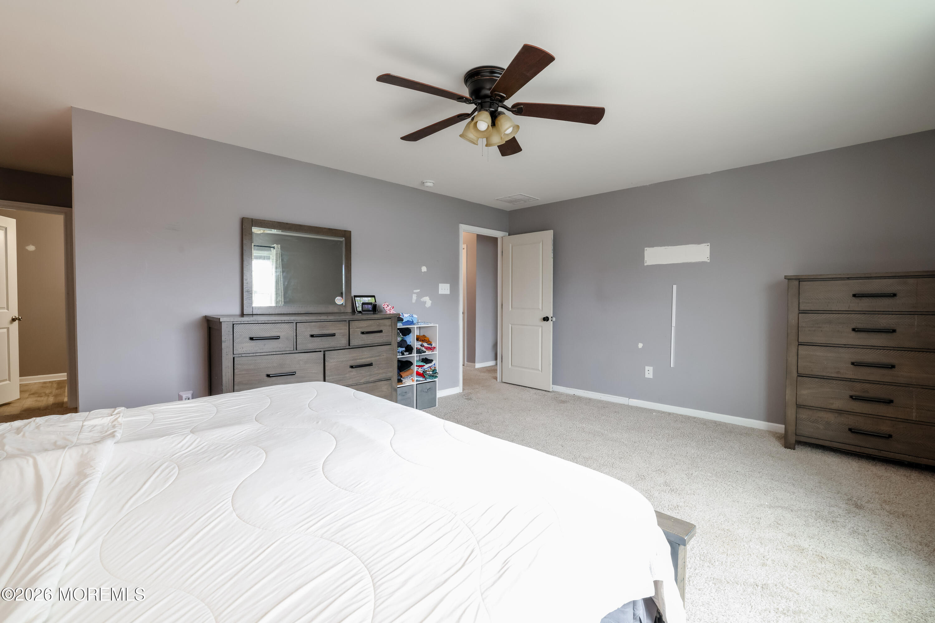 28 Dylan Boulevard Barnegat, NJ 08005 - Photo 29 of 51 a bedroom with a bed and a chandelier