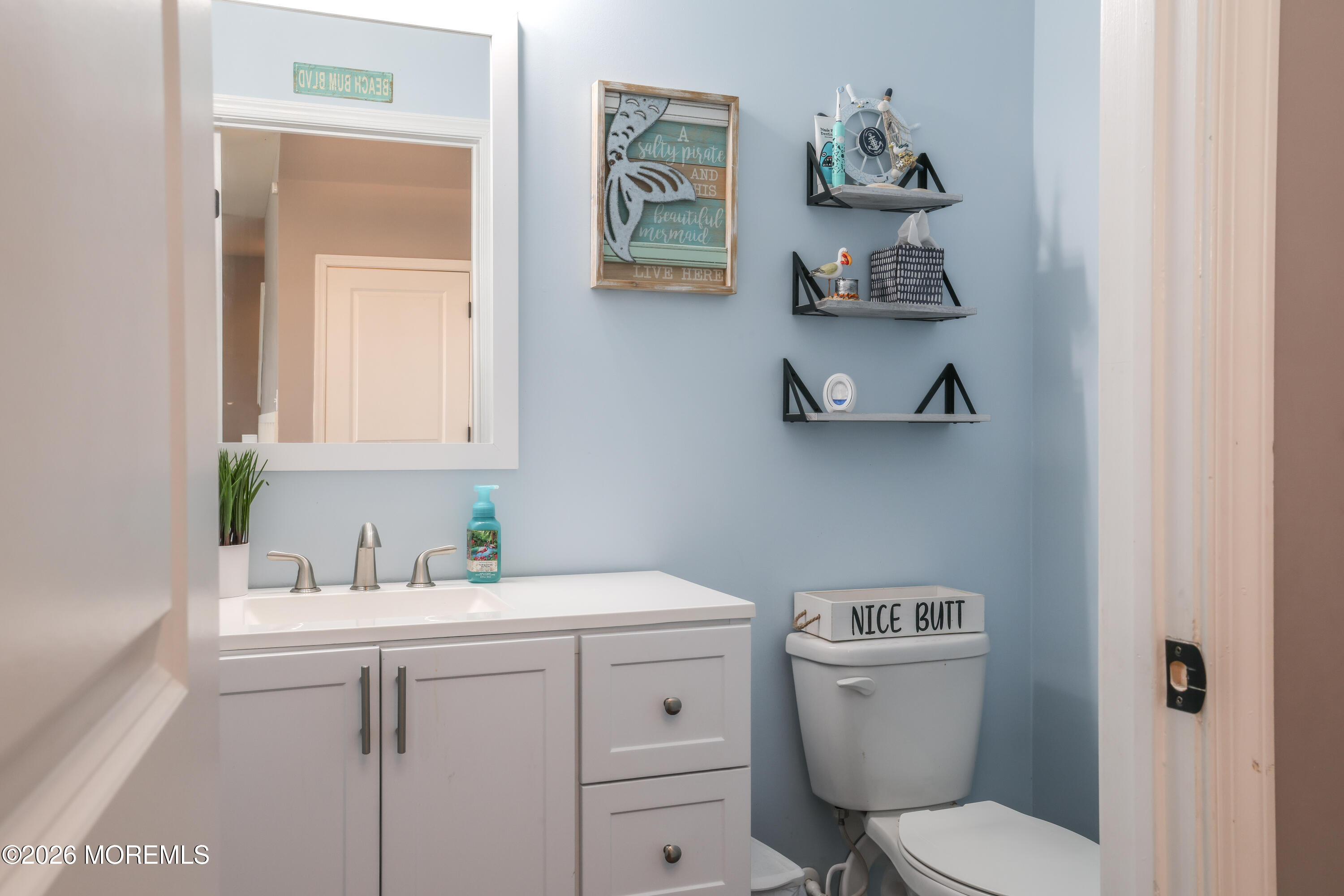 28 Dylan Boulevard Barnegat, NJ 08005 - Photo 9 of 51 a bathroom with a toilet sink and mirror