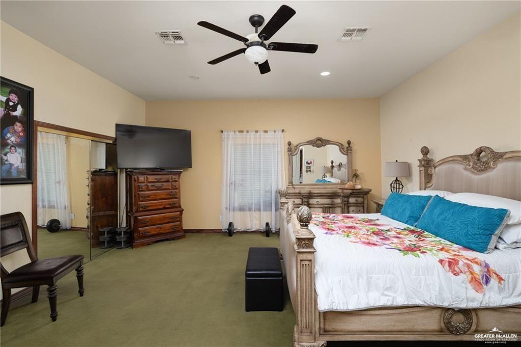 4523 South Tower Road Edinburg, TX 78542 - Photo 23 of 32 a bedroom that has a bed and a chandelier