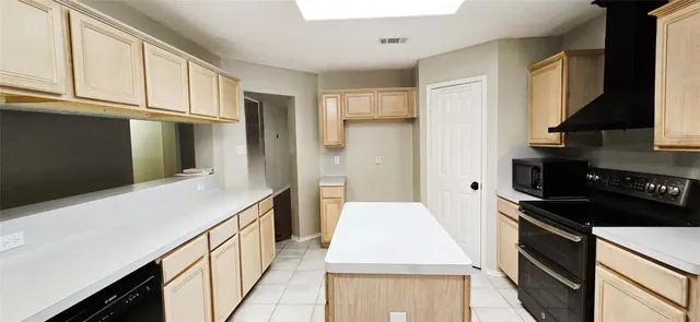 a kitchen with stainless steel appliances a stove refrigerator sink and cabinets