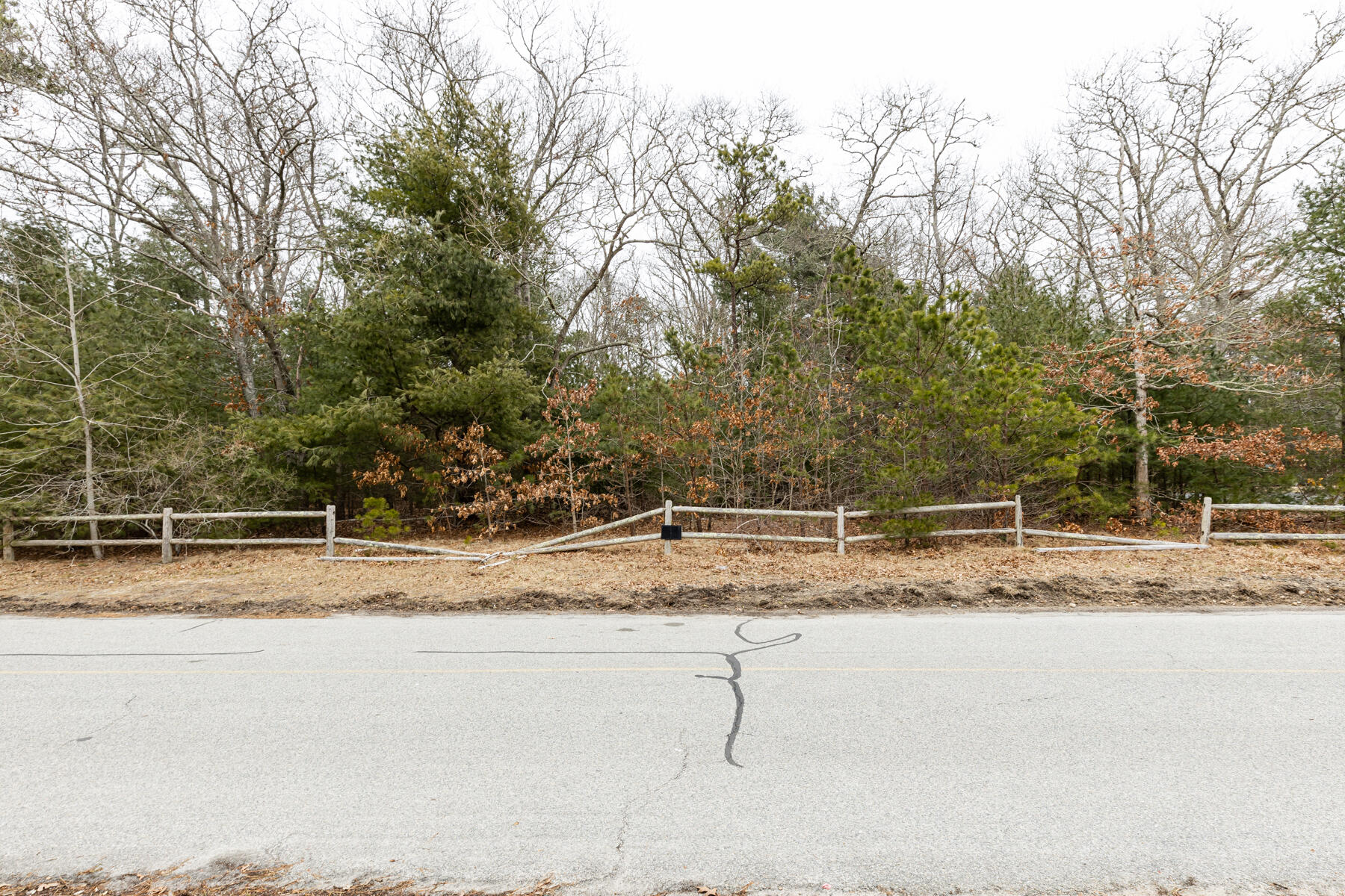 109 Old Brickyard Road Mashpee, MA 02649 - Photo 2 of 3 a view of a yard with wooden fence