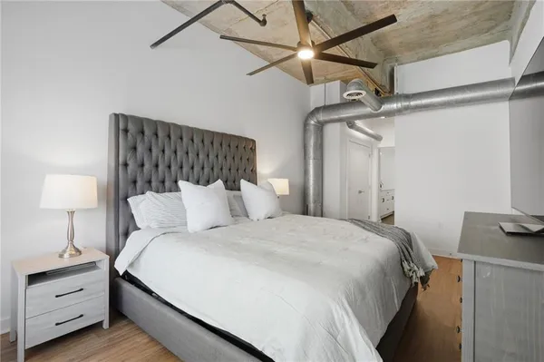 a bedroom with a bed and a lamp
