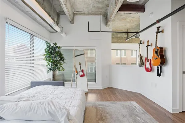 a bedroom with a bed and a potted plant