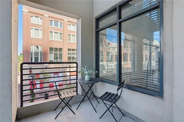 a view of a room with a window and balcony