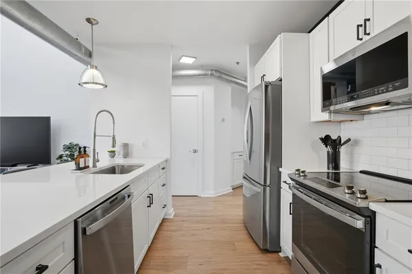 a kitchen with a sink stainless steel appliances and cabinets
