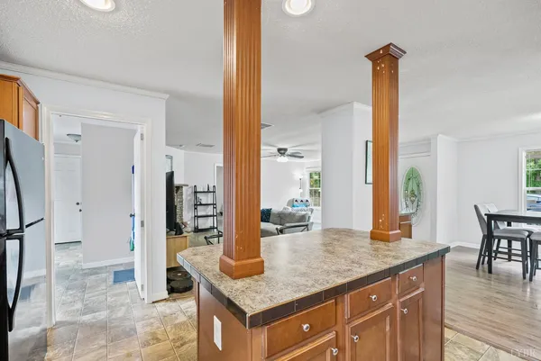 a kitchen with stainless steel appliances granite countertop a sink and a refrigerator