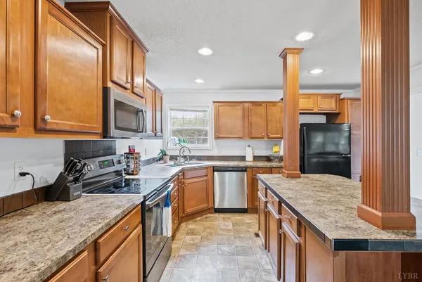 a kitchen with a stove a sink a refrigerator and window