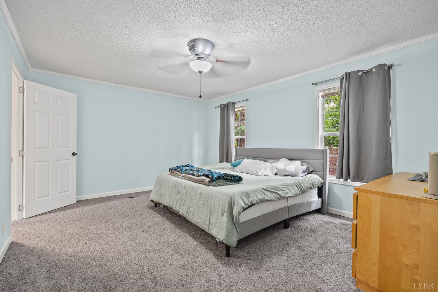 6124 Old Courthouse Road Appomattox, VA 24522 - Photo 5 of 52 a bedroom with a bed and a chandelier