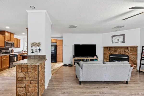 a living room with furniture a flat screen tv and a fireplace