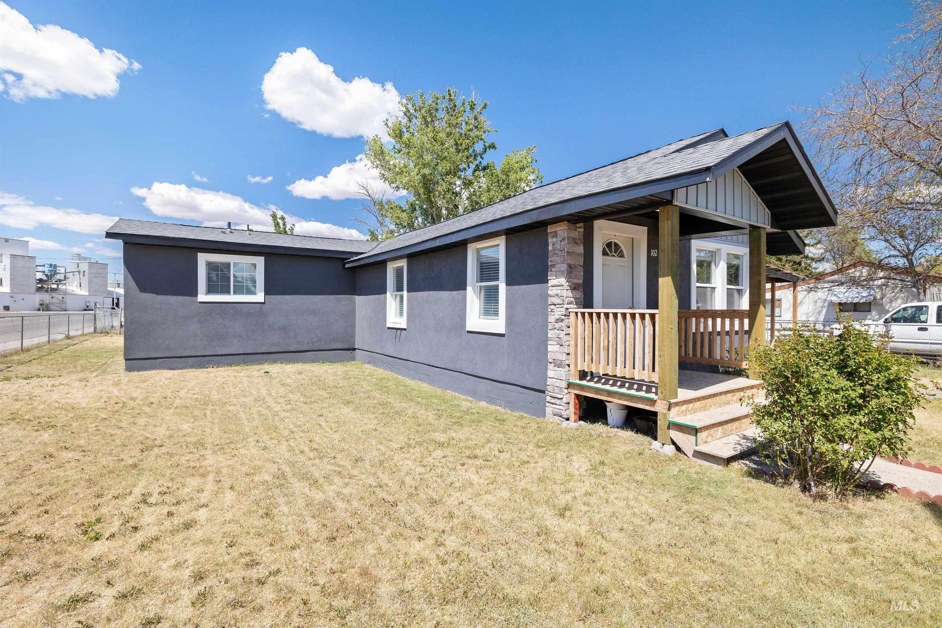 102 East 6th Street Rupert, ID 83350 - Photo 21 of 27 Renovated exterior featuring dark gray stucco siding and a stone veneer accent