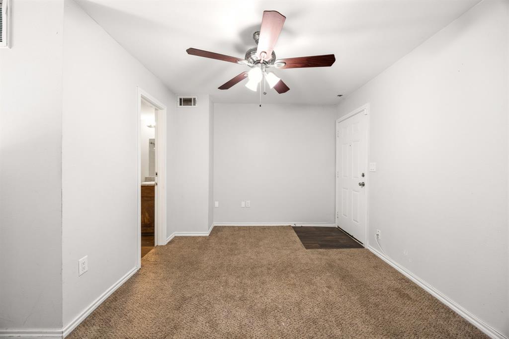 9837 Walnut Street, Unit S203 Dallas, TX 75243 - Photo 18 of 26 This room features carpeted flooring, a ceiling fan with integrated lighting, and a white entrance door
