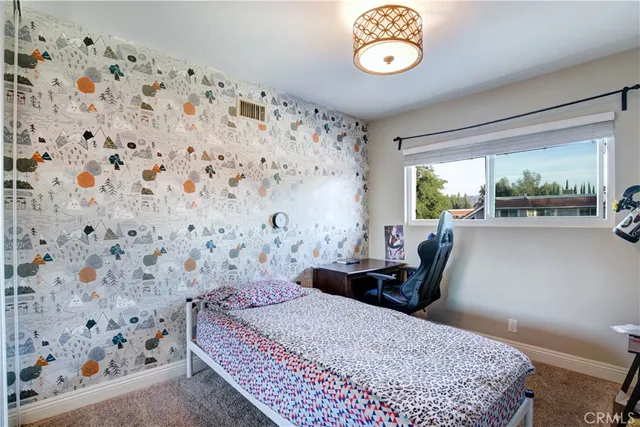 a living room with a couch and a chandelier