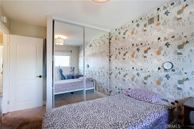 a bedroom with a bed and a view of bathroom