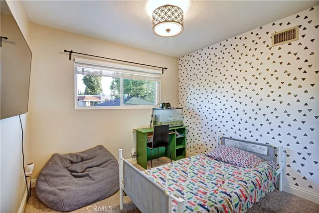 a bedroom with a bed and a chair with the outer view