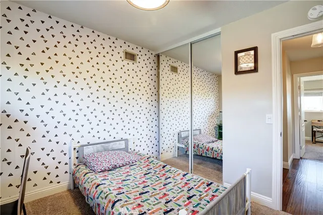 a bedroom with a bed and a lamp next to a window