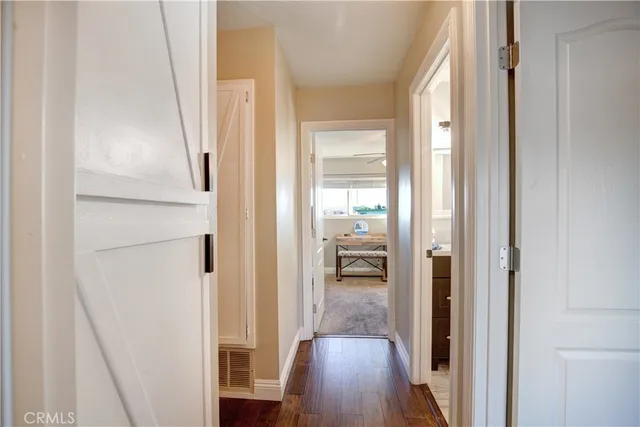 a view of a hallway with wooden floor fireplace and living room
