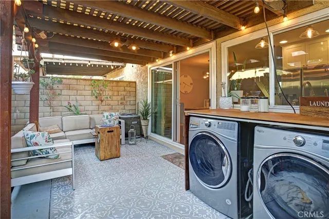a view of a living room and washer and dryer