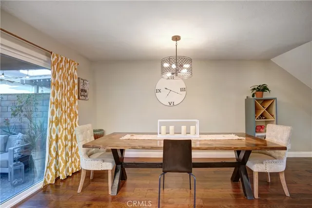 a view of a dining room with furniture wooden floor and chandelier