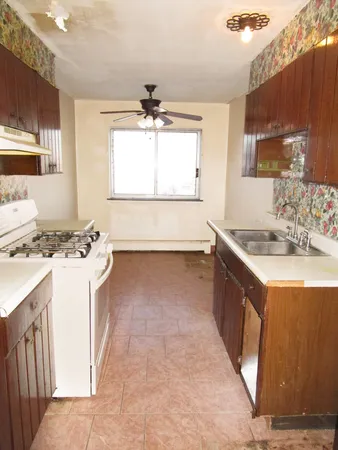 a kitchen with a sink stove and microwave
