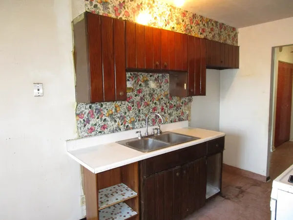 a room with a sink and cabinets