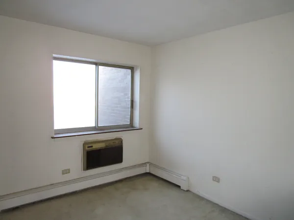an empty room with a fireplace