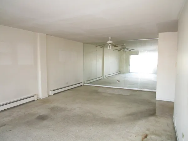 an empty room with a empty space and windows