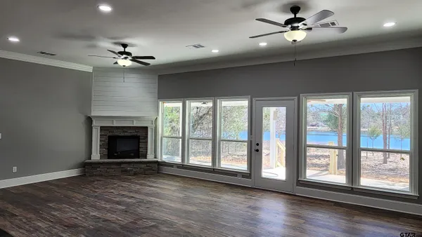 a view of an empty room with a fireplace and a window