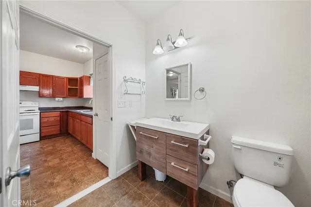 a view of a patio with table and chairs with wooden floor and fence
