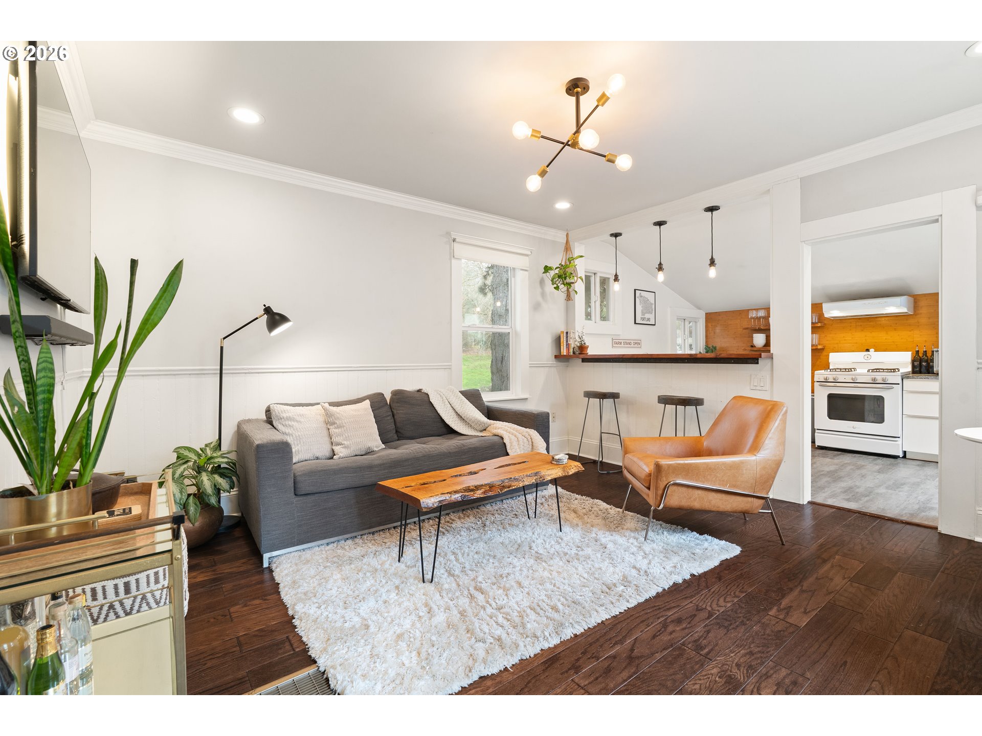 3017 South Water Avenue Portland, OR 97201 - Photo 3 of 31 a living room with furniture wooden floor and a chandelier