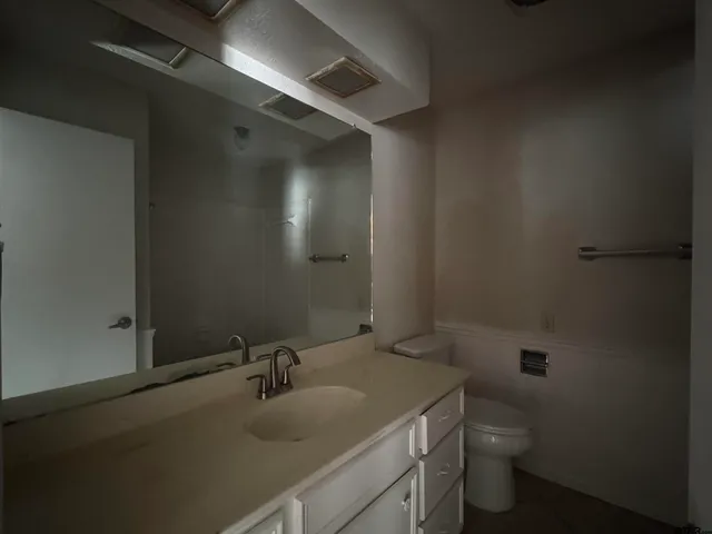 a bathroom with a sink toilet and vanity